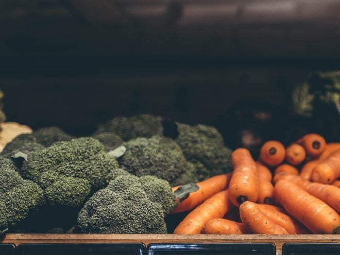 Fresh brocolli and carrots placed on the vegetable stall inside Farmer Copleys Farm Shop in West Yorkshire.